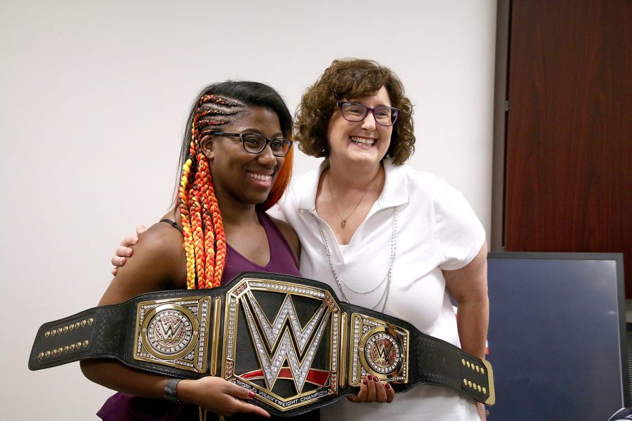 Adrienne Reese presents a championship belt to LC