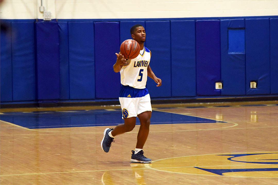 Senior Jemarcus Caldwell dribbles the ball down the court.