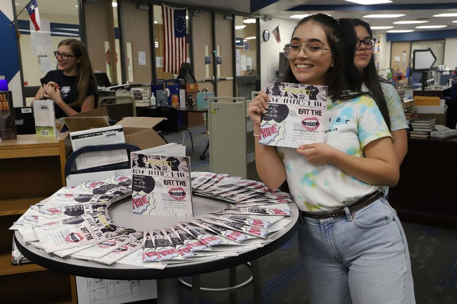 Junior Caroline Aguilar poses with literary magazine.