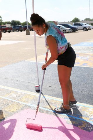 Senior Malaya Samuel paints her parking spot.