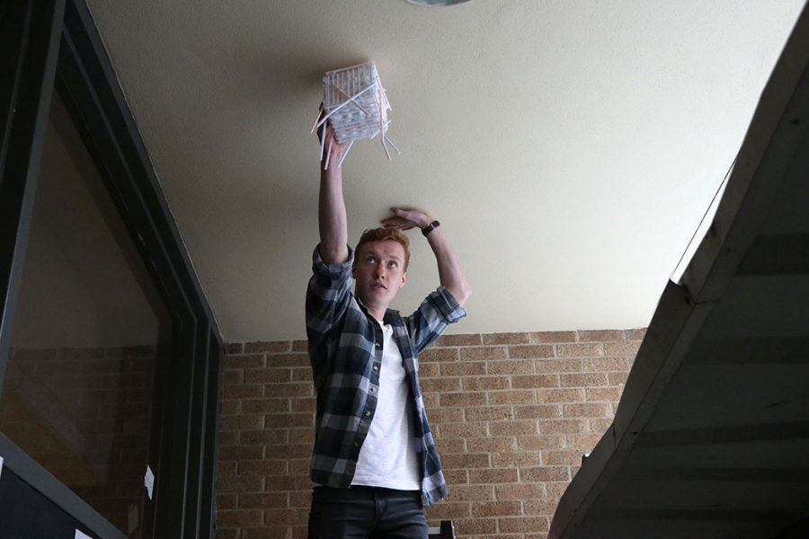 Student participating in physics egg drop